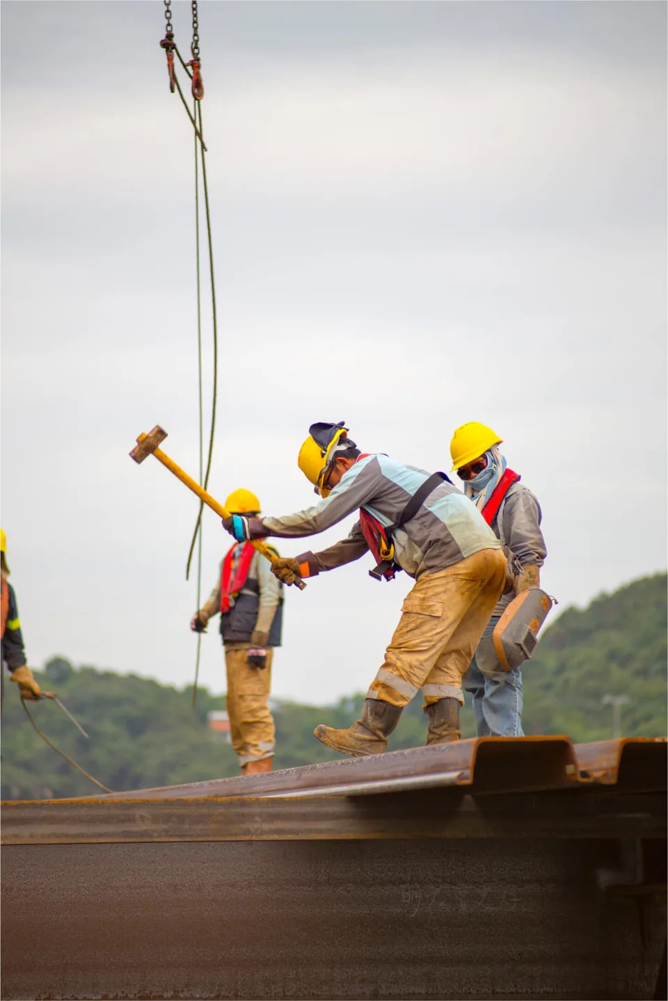 Three men working in a construction site.